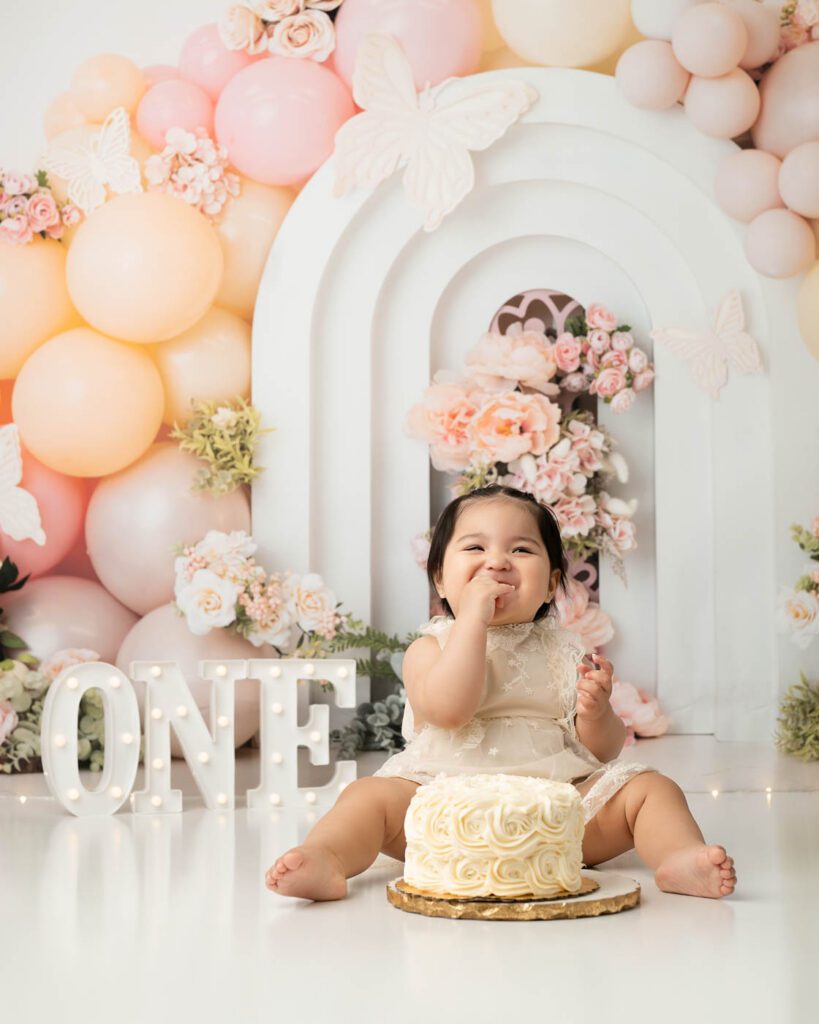 One Year Old Girl Eating Birthday Cake During Cake Smash Photography Session