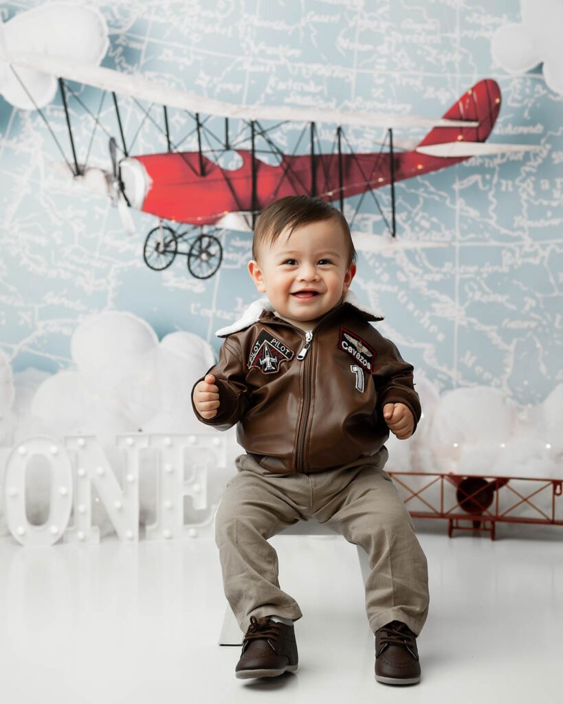 Smiling Baby During A Vintage Airplane First Birthday Photography Session In Dallas