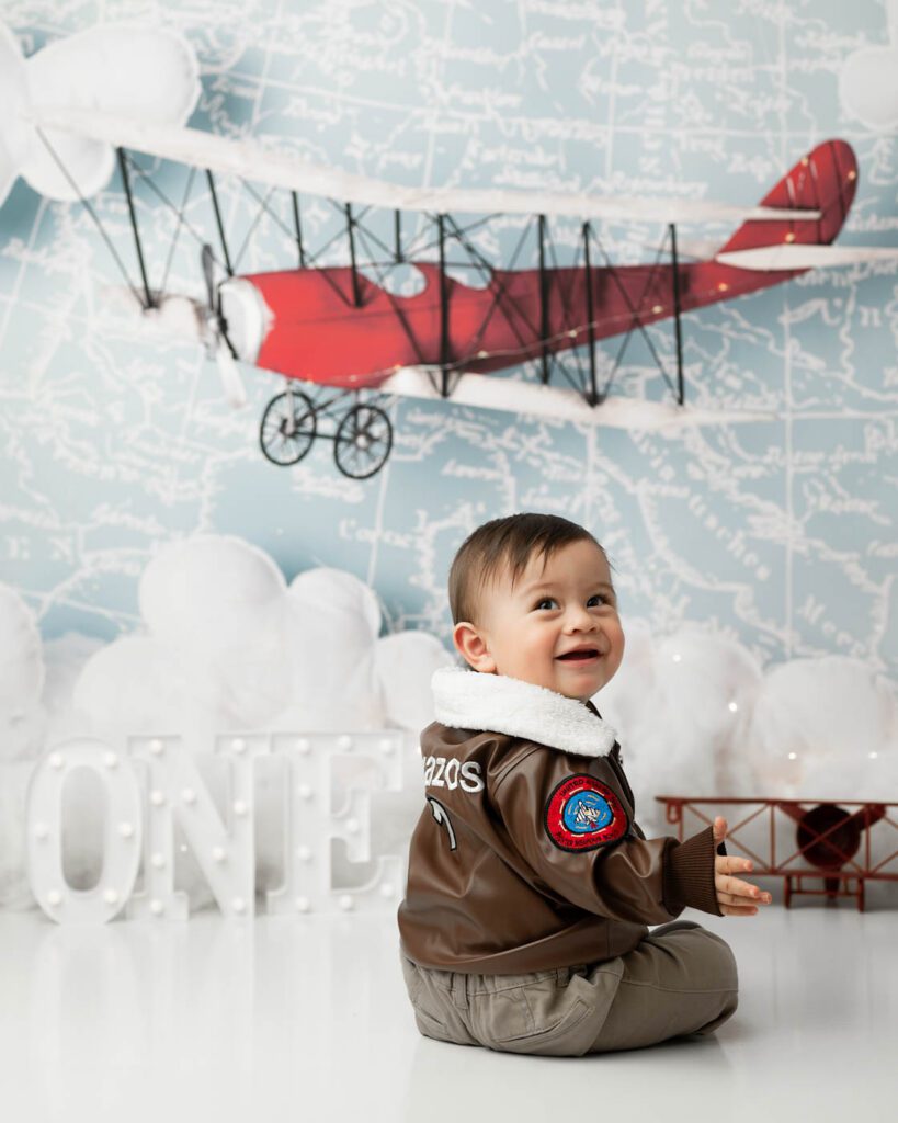 First Birthday Milestone Portrait With A Vintage Airplane Backdrop In Dallas.