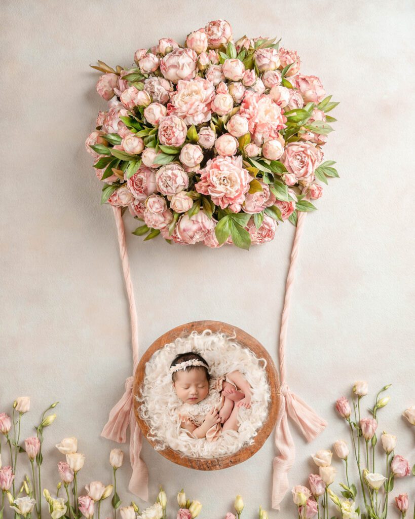 Newborn Baby Girl Photographed In A Floral-Themed Studio Setup By A Dallas Newborn Photographer