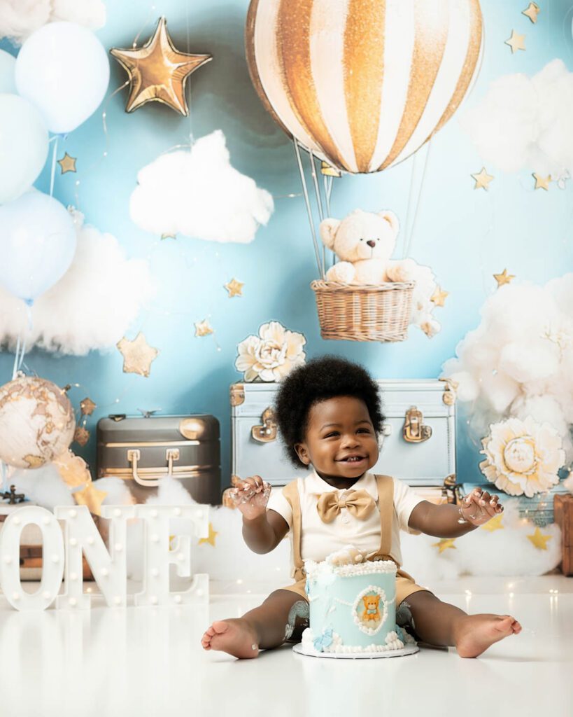 Smiling Baby Enjoying Birthday Cake During A Dallas Cake Smash Photography Session.