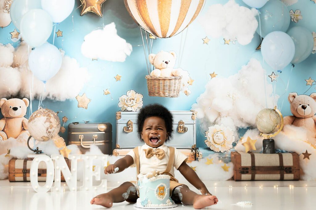 Baby Laughing Beside A Birthday Cake During A First Birthday Session In Dallas.