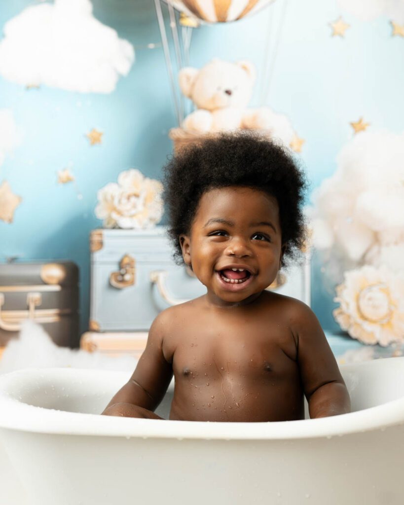 Smiling One-Year-Old Photographed During A First Birthday Portrait Session In Dallas.