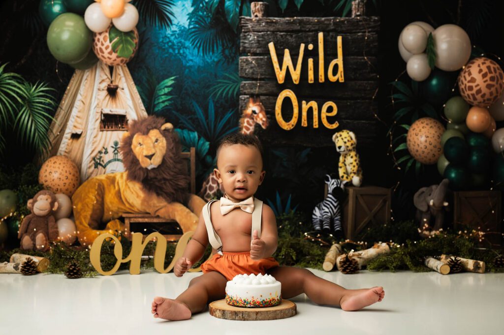 Cake Smash Theme Ideas For Your Baby'S First Birthday 11 Safari Cake Smash Theme Designed By A Dallas Cake Smash Photographer Featuring A Jungle-Inspired First Birthday Setup With Wild Animals, Greenery, And A Birthday Cake.