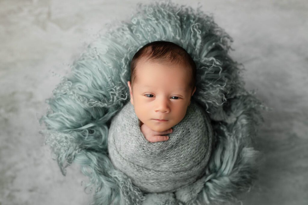 What Happens If My Baby Won’t Sleep During A Newborn Session? 15 Wrapped Baby With Eyes Partially Open During Newborn Photography In Dallas