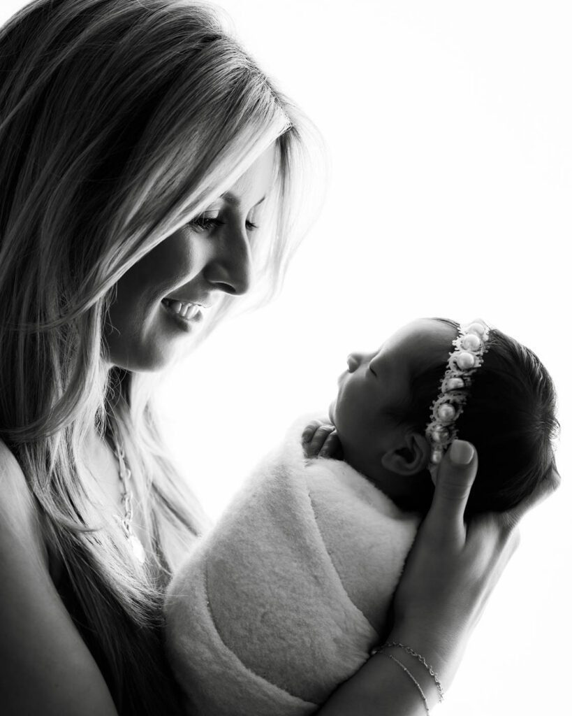 What Happens If My Baby Won’t Sleep During A Newborn Session? 18 Mother Holding Her Newborn Daughter During A Newborn Family Photography Session In Dallas