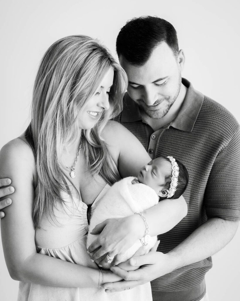 What Happens If My Baby Won’t Sleep During A Newborn Session? 21 Parents Holding Their Sleeping Newborn Baby During A Dallas Newborn Photography Session