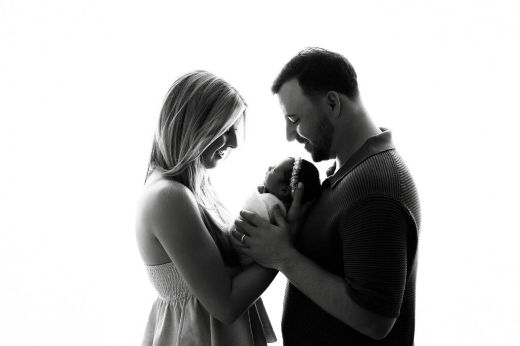 What Happens If My Baby Won’t Sleep During A Newborn Session? 20 Parents Holding Their Newborn Baby During A Professional Newborn Photography Session In Dallas