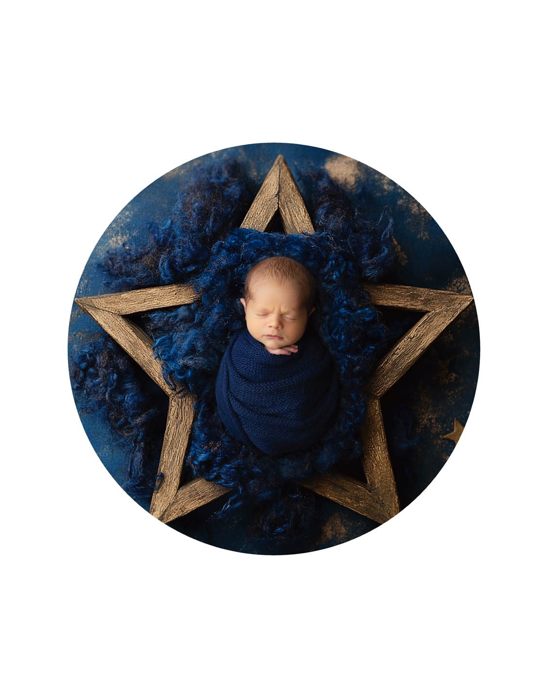 Dallas newborn photography featuring a peacefully sleeping newborn baby wrapped in navy blue and posed in a rustic wooden star during a fine art studio session.